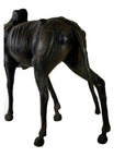Brown leather gnu sculpture showing back legs, ribcage, and torso on a white background.