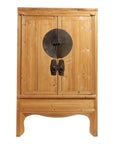 Natural wood Chinese armoire with double doors, medallion hardware, and decorative center handles.
