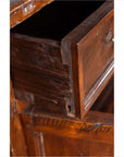 Close-up of brown teak wood cabinet with open drawer, showing visible scratches and wear.