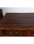 Close-up of a brown teak cabinet with four drawers and four double doors, vintage details visible.