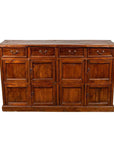 Brown teak wood cabinet with four drawers and four pairs of double doors, early 20th century, indoor setting.