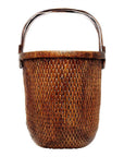 Natural woven basket with sturdy handle, suitable for storing magazines, displayed on a white background.