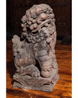 Gray stone lion statue with curled mane on a detailed carved wooden floor, Late Ming Dynasty, 16th-17th c. China.
