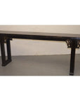 Brown wood Chinese altar table with carved spandrels and gold-accented side supports, set against a plain background.