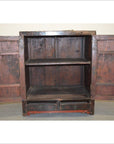 Black and red wood cabinet with open doors, interior shelf, and two small bottom drawers, indoor setting.