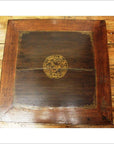 Dark wood square Kang coffee table with gilt decorated center, visible surface scratches and cracks, close-up view.