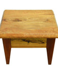 Brown mango wood side table with four legs, vintage style, and single front drawer with round brass pull.