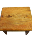Brown mango wood side table with visible grain, front drawer, and brass pull on a white background.