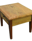 Natural finish mango wood side table with curved edges and front drawer featuring a brass pull, close-up view.