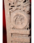 Brown wood Ming Dynasty Chinese temple carvings with figures, floral, and circular motifs on black bases, close-up.