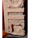 Brown wood Ming Dynasty Chinese temple carvings with figures, floral, and circular motifs on black bases, close-up.