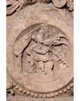 Brown wood Ming Dynasty Chinese temple carvings with figures, floral, and circular motifs on black bases, close-up.