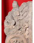 Brown wood Ming Dynasty Chinese temple carvings with figures, floral, and circular motifs on black bases, close-up.