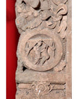Brown wood Ming Dynasty Chinese temple carvings with figures, floral, and circular motifs on black bases, close-up.