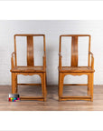 Brown wood and rattan wedding armchairs in Ming Dynasty style with curved arms, on wooden floor, color chart in front.