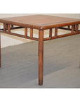 Dark wood Ming style coffee/side table with rounded legs and decorative supports on a gray wooden floor.
