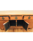 Natural wood altar coffer with three drawers, two open cabinet doors, and decorative brass hardware.