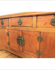 Natural wood altar coffer with three drawers, two cabinets, and decorative brass hardware, front view.