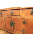 Natural wood altar coffer with three drawers, two cabinets, and decorative brass hardware, front view.