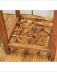 Natural wood lamp and tea table with lattice shelf, rustic wooden floor background.