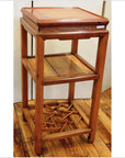 Natural wood lamp and tea table with three shelves and a bottom shelf featuring a decorative lattice design.