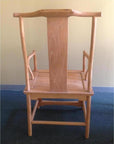 Natural wood Yoke Back Chair upside down on blue carpet, beige wall background.