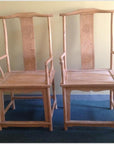 Natural wood Yoke Back Chairs, pair, side by side against a light-colored wall.