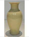 Off-white crackle porcelain vase with glossy finish, narrow neck, and flared rim on plain background.