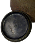 Close-up of a dark metal Old Japanese teapot lid with Japanese characters inscribed underneath, in good condition.