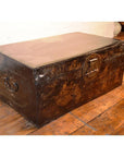 Dark wooden vintage chest with metal handles and lock on a wooden floor.