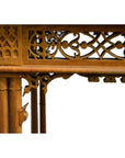 Close-up of a dark wood hand-carved table with intricate carvings and geometric patterns.