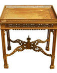 Brown wood hand carved table with ornate intricate detailing and raised decorative border on tabletop, close-up view.