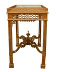 Brown wood hand-carved table with lattice design, carved details, four legs, and decorative braces.