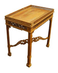 Brown wood hand carved table with intricate latticework and detailed carvings on legs and edges, close-up view.