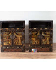 Black lacquered wood Chinese display cabinets with hand painted chinoiserie motifs, round metal handles, on wooden floor.