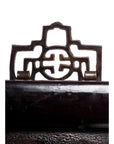 Close-up of brown Chinese wood carvings with ornate geometric and circular patterns on a white background.