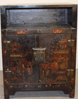 Black lacquer antique Chinese display cabinet with faded red and gold motifs, double doors, open shelf design.