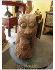 Brown wood Indian Guardian Lion carvings on display in an antique shop.