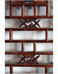 Close-up of brown wooden 2-panel screen with open fretwork design and rectangular frames.