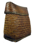 Close-up of brown handwoven rattan basket with wide base and slightly folded top, Philippines style.