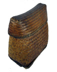 Brown rattan rectangular basket with curved lid and herringbone pattern, close-up.