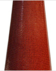 Close-up of a red ceramic vase with textured, scale-like pattern and cone shape.