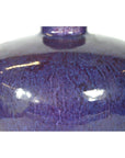 Close-up of deep purple glazed ceramic vase with glossy finish and visible light reflections, very good condition.