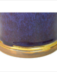 Close-up of glossy dark blue ceramic vase with brown base, in very good condition.