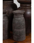 Brown wooden ghee pots in sets of 3, 5, or 7 on a rustic wooden surface.