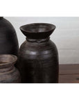 Brown wooden ghee pots in a set of three on a wooden surface with a light background.