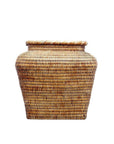Brown rattan square basket with wide body, tightly woven, on a white background.
