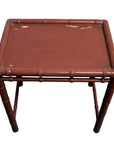 Red bamboo side table with square top and bamboo-style legs on white background.