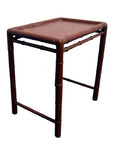 Red bamboo side table with rectangular top and bamboo-inspired legs, accent piece for home decor.