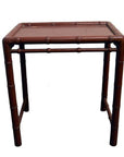 Red bamboo side table with bamboo-style legs and flat top, modern style furniture for interior use.